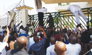 House of Representatives members scaling the gate