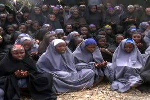 A screengrab taken on May 12, 2014, from a video of Nigerian Islamist extremist group Boko Haram obtained by AFP shows girls, wearing the full-length hijab and praying in an undisclosed rural location. Boko Haram released a new video on claiming to show the missing Nigerian schoolgirls, alleging they had converted to Islam and would not be released until all militant prisoners were freed.  A total of 276 girls were abducted on April 14 from the northeastern town of Chibok, in Borno state, which has a sizeable Christian community. Some 223 are still missing.