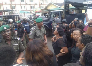 Police officers in altercation with the protesting women barricaded at Waterlines junction before firing teargas at them.