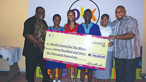 Foster (left); a pupil of Pacelli School, Light Onodu; Masha; another pupil, Jacob; an official of the school, Agnes Onwudiwe; and Adibua; during the presentation of the cheque.
