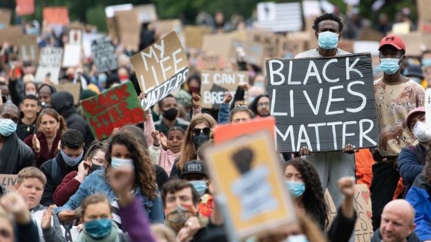 Protesters hold up placards in Cardiff