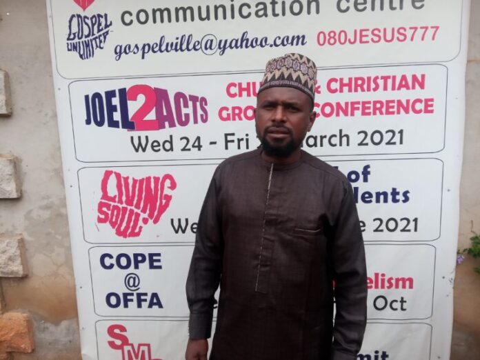 Fulani-Christian standing behind a banner Fulani herdsman