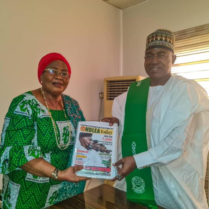 NCWS partners. Marwa -presenting -NDLEA official- -magazine- to- the- NCWS -President-, Mrs.- Shoda- when -she- led -some- officers- of- the -Council- on -a- courtesy- visit- to- the Agency’s- headquarters- in -Abuja