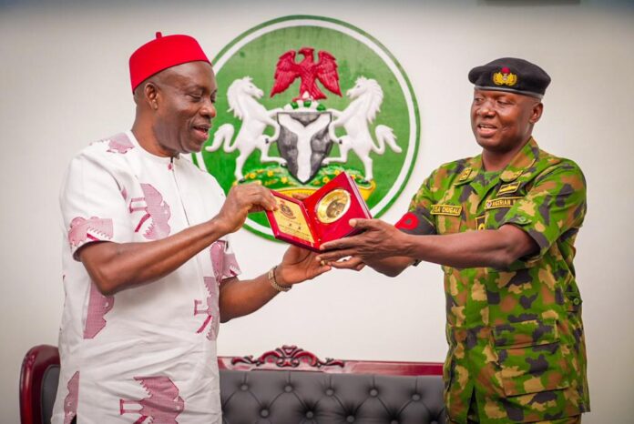 Charles Soludo and officer of Nigerian Navy