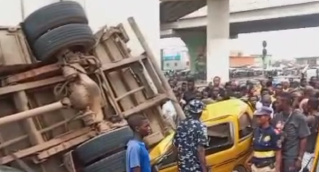 Truck plunges off Pen Cinema Bridge in Lagos, lands on 2 commercial buses